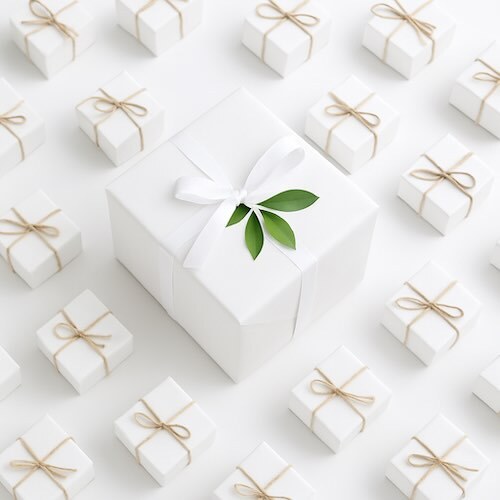 one large white gift box among smaller white gift boxes